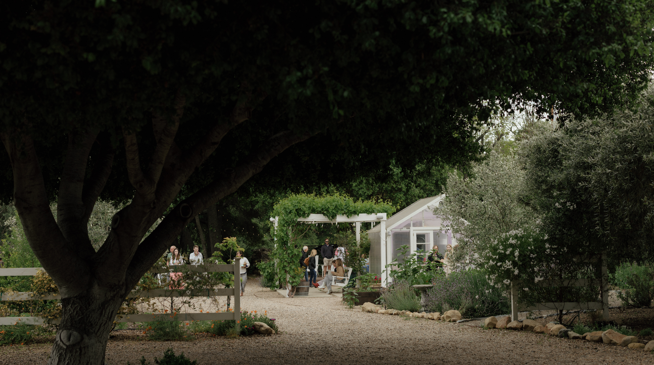 Garden scene with a gazebo and people under trees