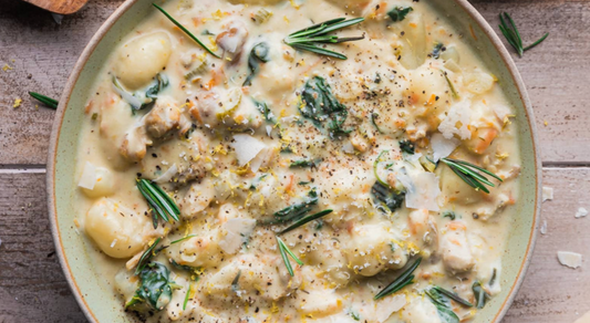 Creamy soup with gnocchi and vegetables in a bowl